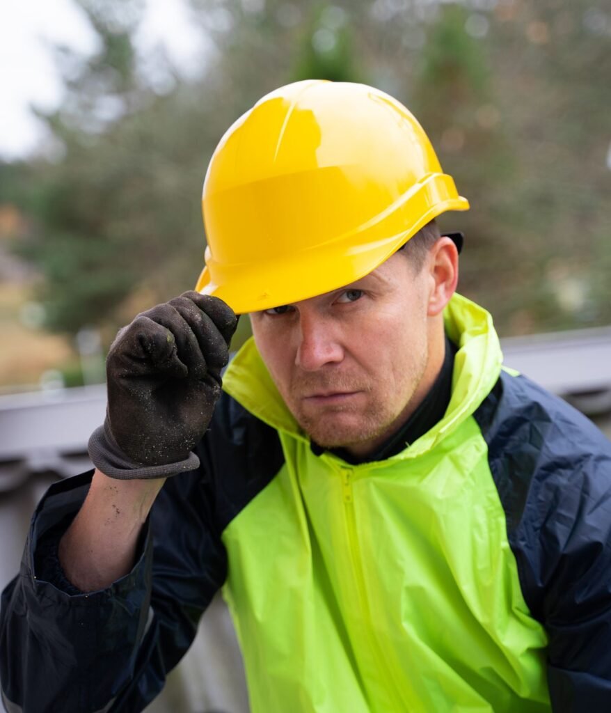 Worker in a yellow hard hat and hi-vis jacket